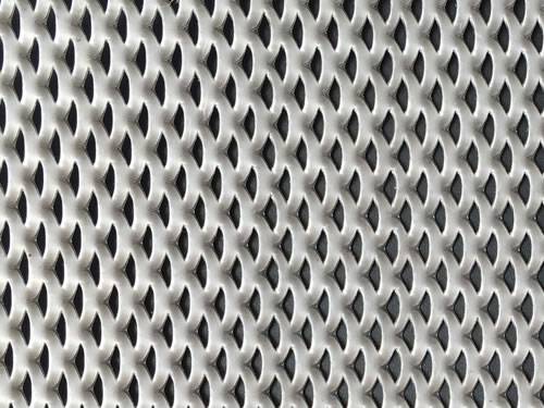 Green aluminum expanded metal meshes with diamond holes are installed on the architectural building facades by trellis.