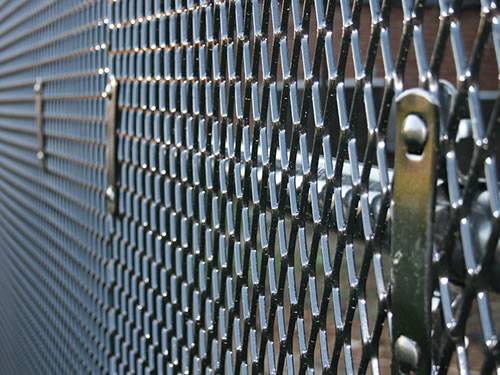 Green aluminum expanded metal meshes with diamond holes are installed on the architectural building facades by trellis.