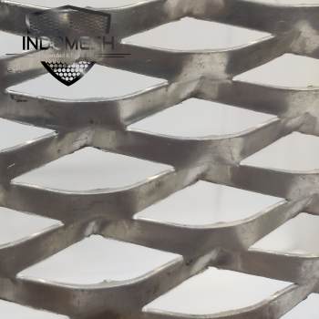 Green aluminum expanded metal meshes with diamond holes are installed on the architectural building facades by trellis.